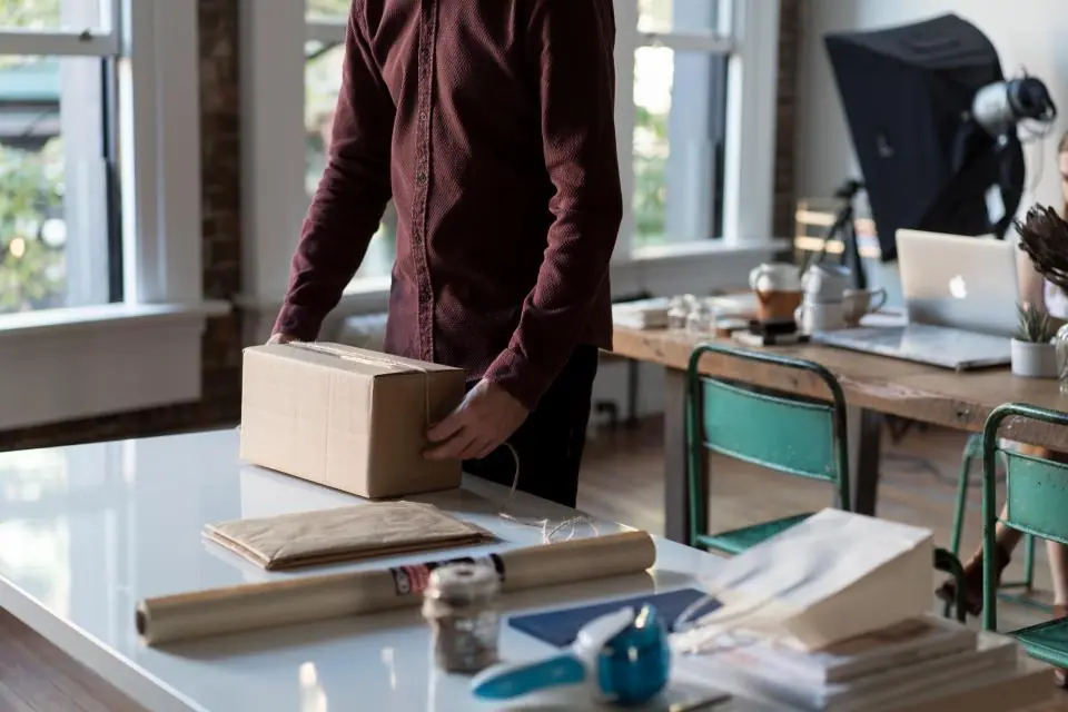 Person packing a box for shipping