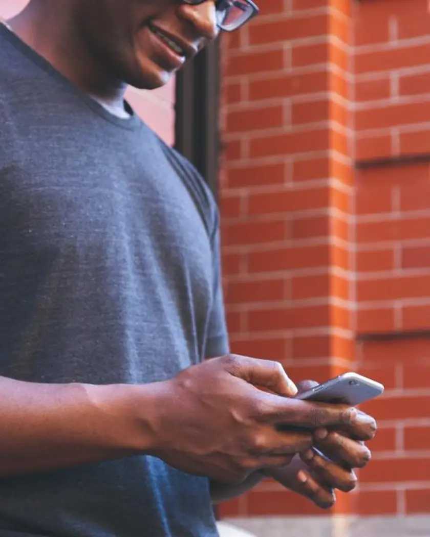 Young man using his phone on the street